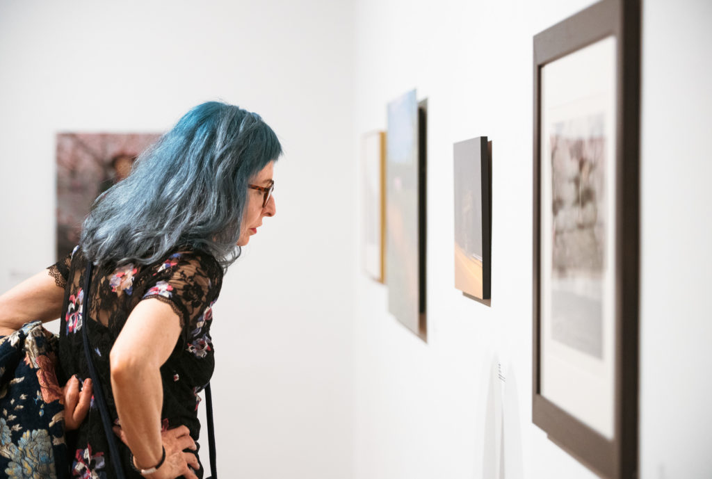 Attendee viewing artwork during the AutoUpdate Exhibition Reception on Friday, October 4, 2019. Photo by Jacob Drabik