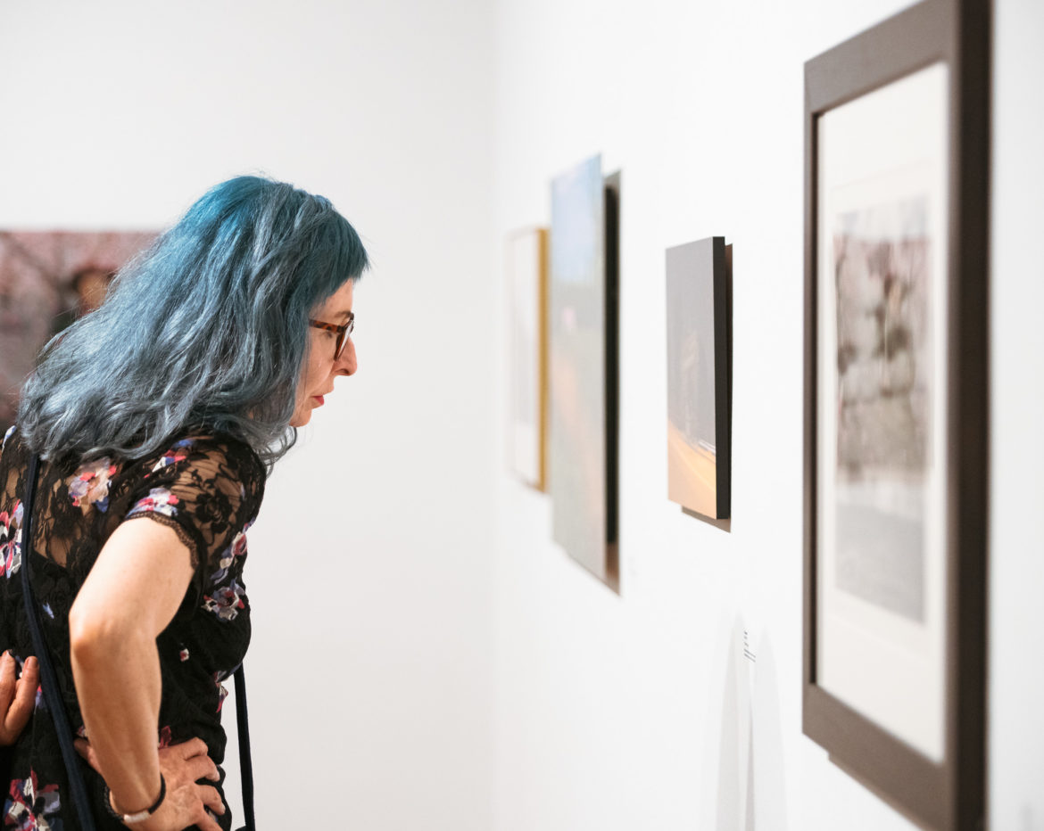 Attendee viewing artwork during the AutoUpdate Exhibition Reception on Friday, October 4, 2019. Photo by Jacob Drabik